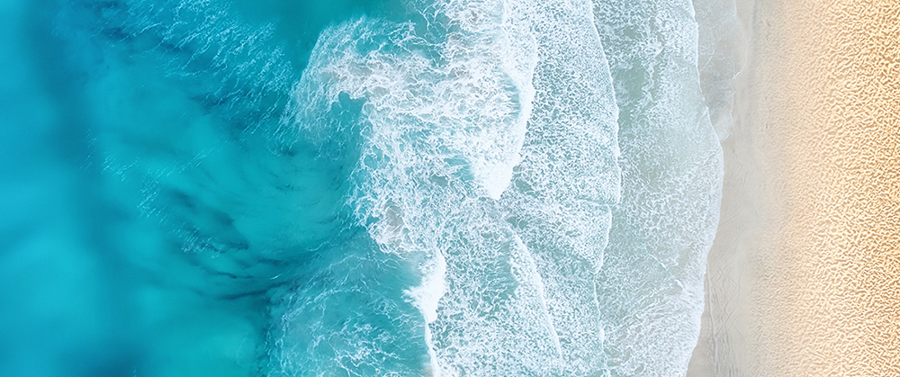 Beach and waves from top view. Turquoise water background from top view. Summer seascape from air. Top view from drone. Travel concept and idea