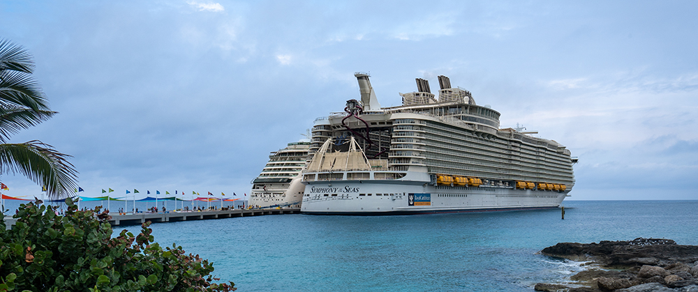 Coco Cay, Bahamas -2023: Symphony of the Seas cruise ship. Operated by Royal Caribbean cruise line. Docked at Royal Caribbean's private island. Oasis Class ship, one of the largest in the fleet.