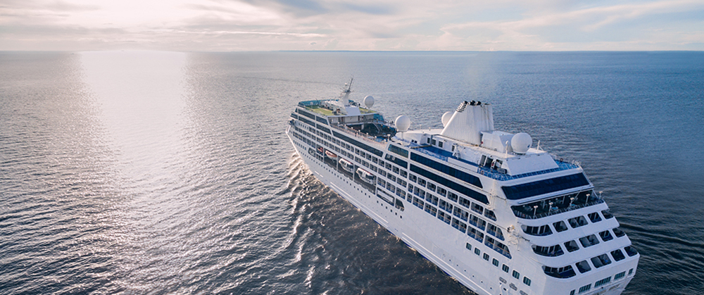 Aerial view of cruise liner sailing in the open sea at sunset